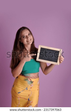 smiling pretty woman holding chalkboard