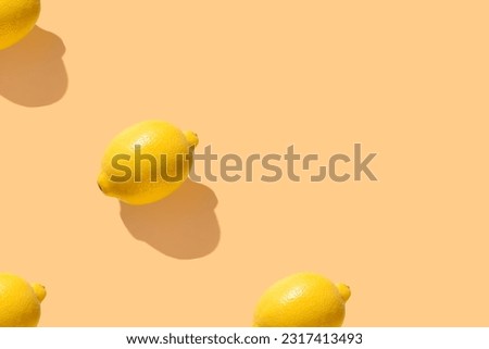 Lemons on yellow pastel soft color with long shadows. Minimal healthy organic food concept. Citrus fruits. Flat lay, top view. Banner. Space for text
