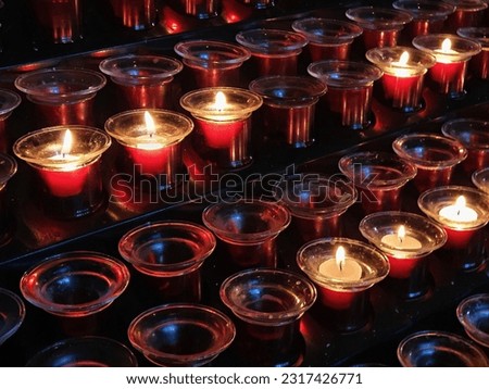 Sacrificial candles that believers light in a Catholic church in front of the altar, or in front of pictures or statues of saints. 