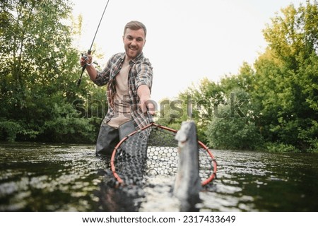 Fishing. Fisherman and trout. Fisherman on wild river