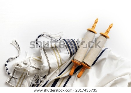 Torah scroll with Tallit on a light background Royalty-Free Stock Photo #2317435735