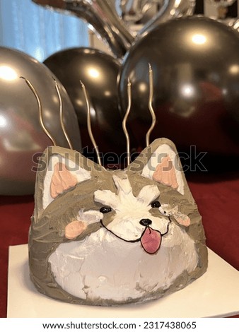 A birthday cake with pictures of pets and balloons.