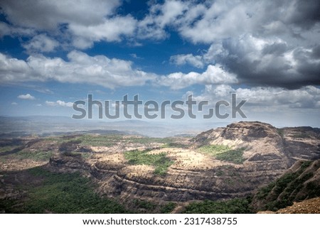 Mountain picture in an overcast weather, blue sky and white clouds