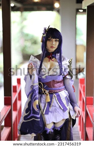 Portrait of a beautiful young woman game cosplay with samurai dress costume