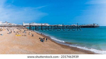 A view along the beach towards the pier in Brighton, UK in summertime Royalty-Free Stock Photo #2317463939