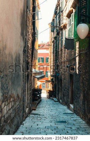 Narrow street of Sibenik town, Croatia. Summer vacation travel background.