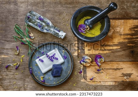 A charming arrangement on a tabletop, showcasing handmade soaps in various shapes and colors, complemented by decorative elements inspired by the theme of soap-making. Royalty-Free Stock Photo #2317473223