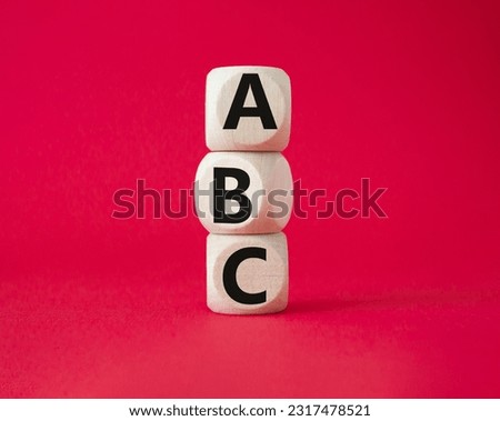 ABC symbol. Concept word ABC on wooden blocks. Beautiful red background. Business and ABC concept. Copy space