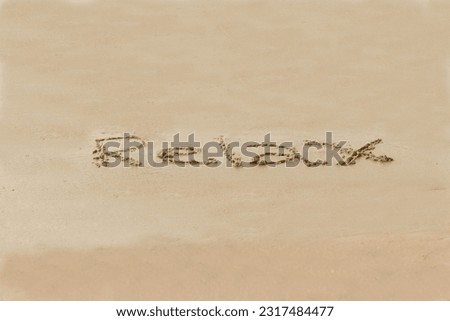 Relax word written in the wet sand of the beach. Healthy lifestyle.
