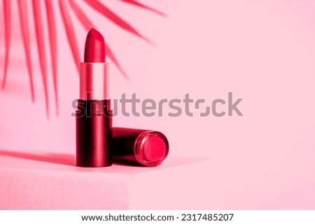 Lipstick at pink background. Toned image. Makeup, cosmetic product.