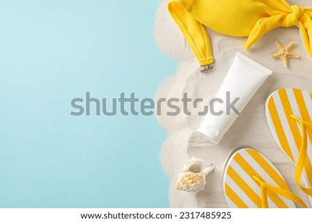 Picture-perfect top view sun protection ensemble: SPF cream tube alongside yellow bodice, flip-flops, shell, starfish on blue and sandy backdrop, featuring space for label or ad within empty space
