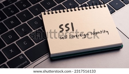 There is notebook with the word SSI Self Sovereign Identity. It is as an eye-catching image. Royalty-Free Stock Photo #2317516133