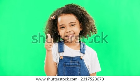 Happy, green screen and face of a child with a thumbs up isolated on a studio background. Winning, success and portrait of a girl kid with an emoji hand gesture for motivation, yes and agreement