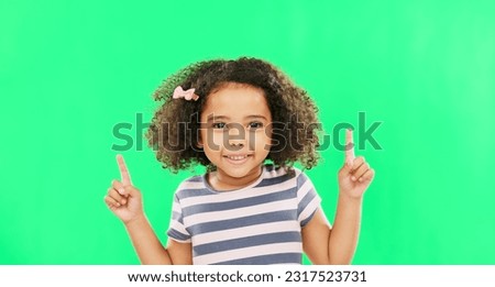 Face smile, girl child and pointing up on green screen in studio isolated on a background. Portrait, emoji and happy kid with hand gesture for mockup, advertising or marketing, branding or chroma key