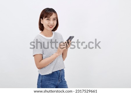 Portrait beautiful young Asian business woman short brunette hair holding a smartphone conversation reacting to info on her mobile phone smiling confidently cheerful facial expression studio shot 