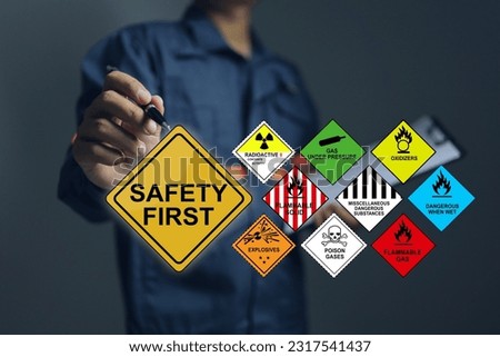 Officers use a pen to point safety signs when working with hazardous substances such as radioactive substances, flammable gases, poisons and general hazardous substances. Dangerous and hazard concept
