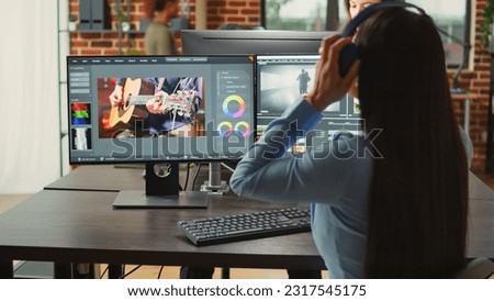 Female cinematographer editing video montage in post production studio office, improving footage quality on creative software. Artist designer working on movie or film, filmmaking industry.