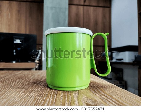 Green mug on wooden table