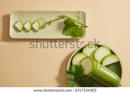 Two dishes in different shapes with winter melon slices displayed on. Winter melon (Benincasa hispida) is one of the popular foods in daily meals in Vietnam. Copy space Royalty-Free Stock Photo #2317554303