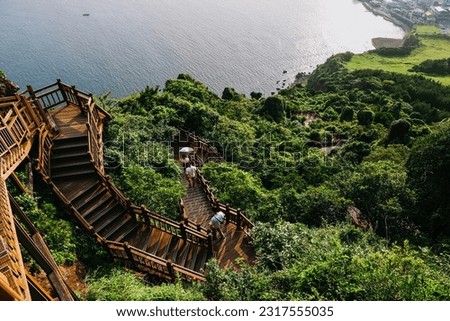 Stairs to climb Seongsan mountain in Jeju Island, South Korea. Royalty-Free Stock Photo #2317555035