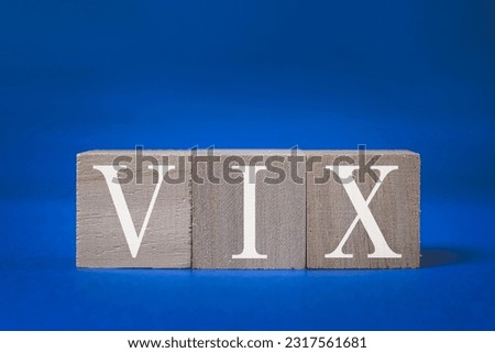 A technical term of VIX on wooden cubes on blue background, Volatility Index, Finance or stock background
