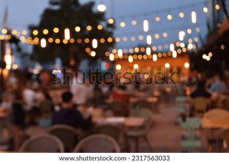 blurred image at the restaurant night time, many people in the restaurant eat and party happy relaxing 