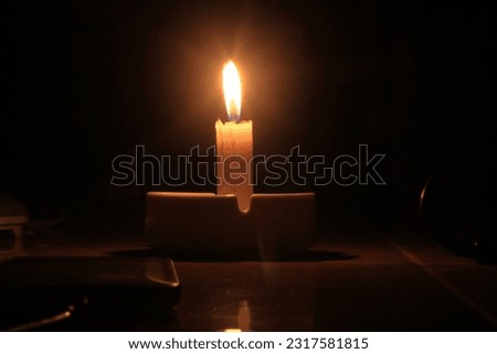 
candle flame in the dark of night
