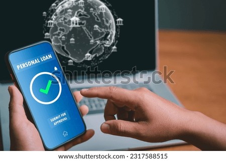 Man used a mobile phone to search for information about applying for a personal loan to choose a bank that suited his financial situation and could pay back with interest without burdening his family. Royalty-Free Stock Photo #2317588515