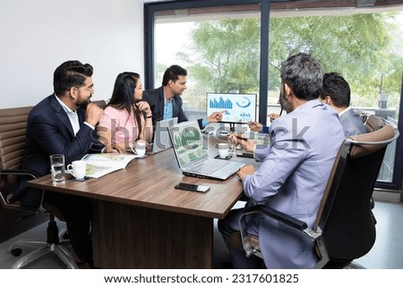 Indian business people meeting presentation in office conference room show Charts Infographics on TV screen, growth profit of company, data analysis.  Corporate job, company roadmap, Finance, Career.  Royalty-Free Stock Photo #2317601825