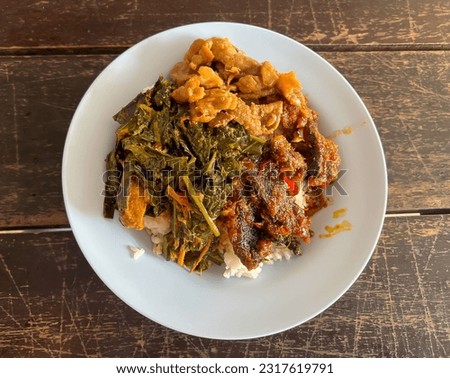 The concept of economic dish meal as curry and rice in Thai's style canteen. Normally, people go to eat in canteen or cafeteria and get rice with various kinds of curry and food. Royalty-Free Stock Photo #2317619791