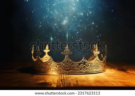 low key image of beautiful queen or king crown over wooden table. vintage filtered. fantasy medieval period Royalty-Free Stock Photo #2317623113