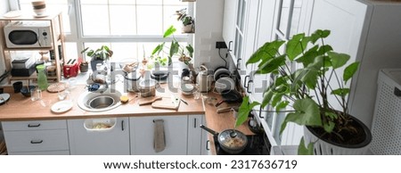 A mess in the kitchen, dirty dishes on the table, scattered things, unsanitary conditions. kitchen is untidy, everyday life Royalty-Free Stock Photo #2317636719