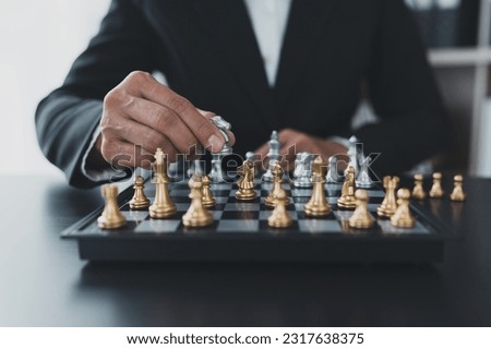 Investor playing chess board game conceptual image of businessman holding chess piece in business competition and risk management Plan a business strategy to beat your competitors. leadership concept Royalty-Free Stock Photo #2317638375