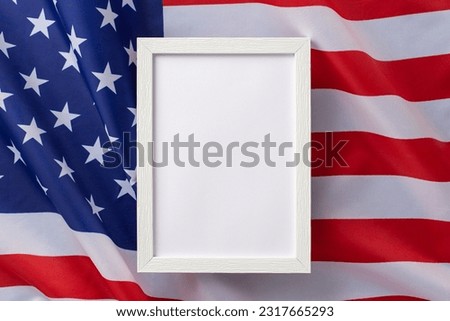 American federal holiday concept. High angle view photo of empty rectangular wooden frame on american flag on isolated background with copy-space