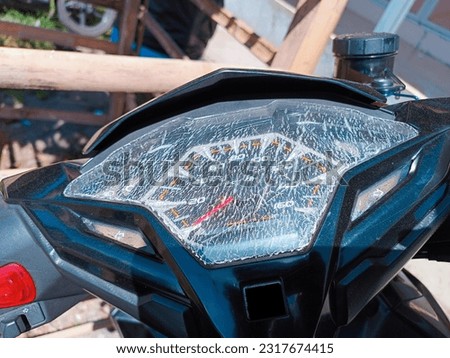 A motorcycle speedometer that cracked the glass due to exposure to heat