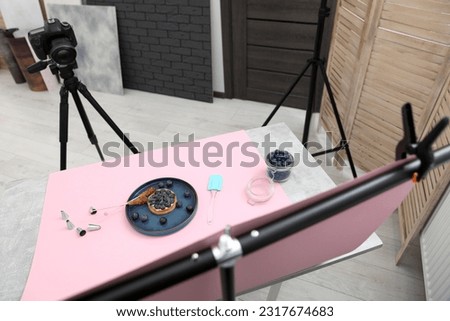 Professional equipment and composition with delicious dessert on pink background in studio, above view. Food photography