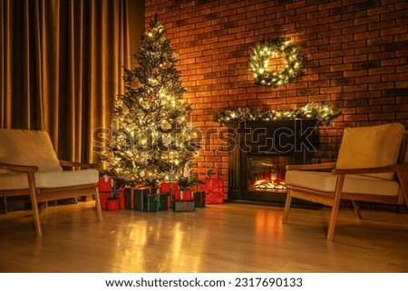 Beautifully wrapped gift boxes under Christmas tree in living room