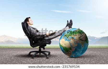 Young confident businessman sitting in chair with book in hands. Elements of this image are furnished by NASA