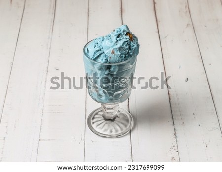 blue planet ice cream scoop served in cup isolated on table top view of dessert