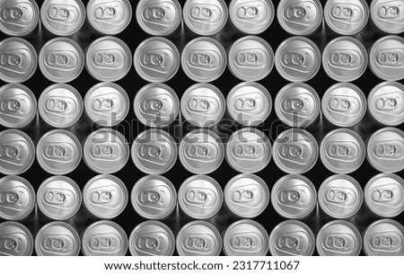 Monochrome color Abstract pattern many soda drinks cans top view on dark background. Recycling aluminum or metal empty cans from above. Group of cans for reuse and recycle. Royalty-Free Stock Photo #2317711067