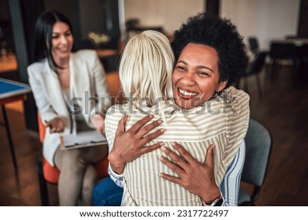 Support group patients hug each other during the therapy session. Group therapy session, addiction treatment or team building. Royalty-Free Stock Photo #2317722497