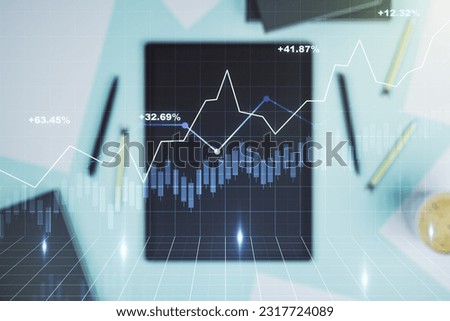 Double exposure of abstract creative financial chart and digital tablet on background, top view, research and strategy concept