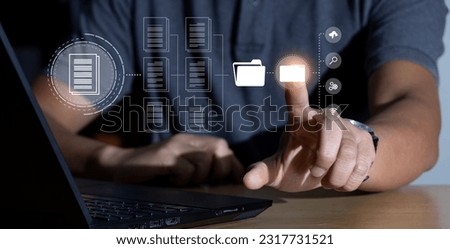 Managing documents and information with a search system concept Businessman using laptop to search virtual folders and online data management. Archive documents. Digital operating system.  Royalty-Free Stock Photo #2317731521