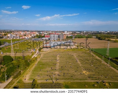 Drone photography field of tulips waveform. Tulips in Bloom in Vimodrone in Milan. Panoramic Skyline Of Milan City 