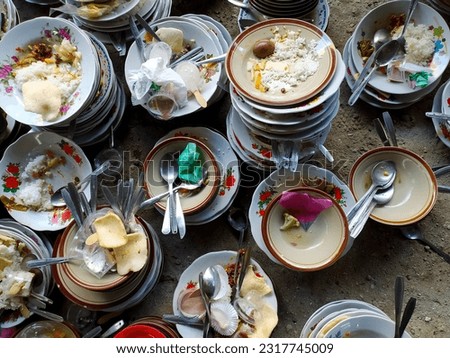 Piles of dirty dishes stock photo.