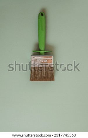 Repair brush on a green background top view, space for your text.