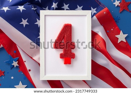 US Independence Day concept. Top view photo of wooden frame with the number 4 surrounded by blue, white and red glitter stars and american flag on blue isolated background