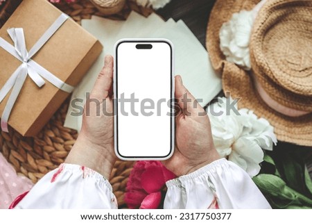 Mobile phone and spring flower peonies on a festive background. Theme of love, mother's day, women's day flat lay.