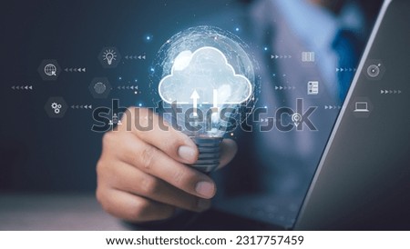 Business hand using light bulb with  cloud computing technology. Storage and data transfer Cloud network , Cloud technology. Networking and internet service concept.