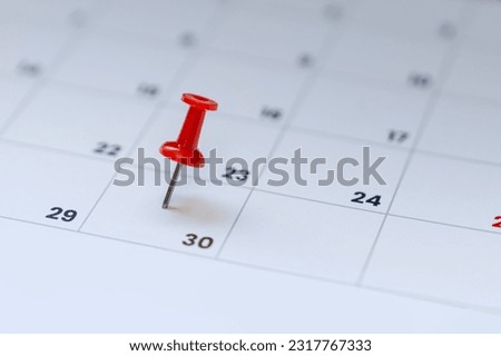 Red pin on calendar 30th day of the month.